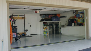Mand, der står foran garagen før montering af en garageporttærskeltætning